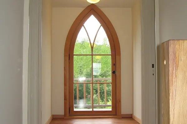 Custom pointed-arch wood door with divided lites