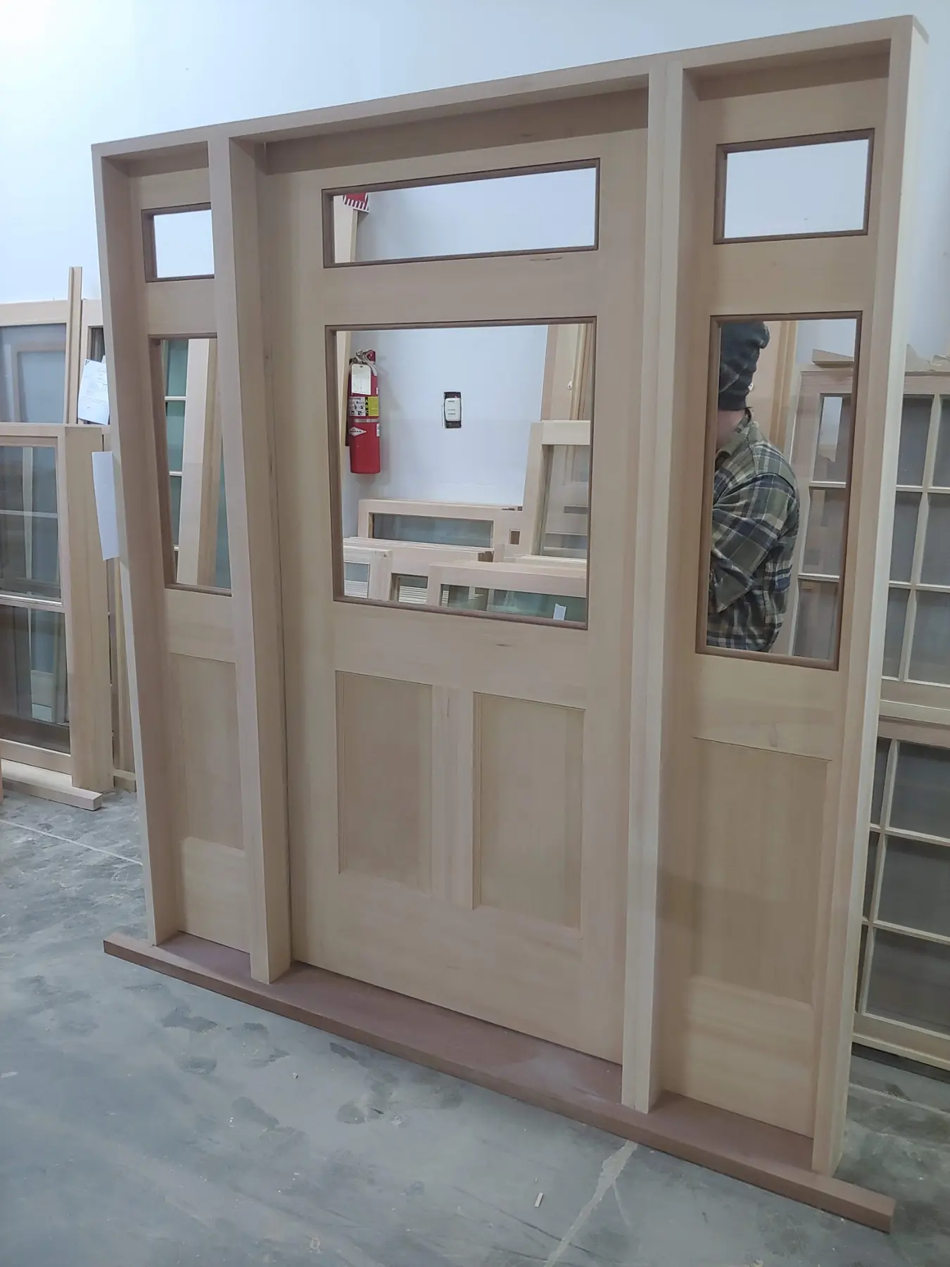 Custom wood entry system with sidelights and transom under construction