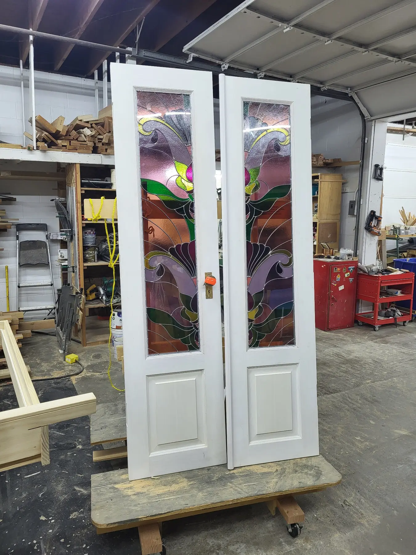 Painted custom double doors with decorative stained-glass panels