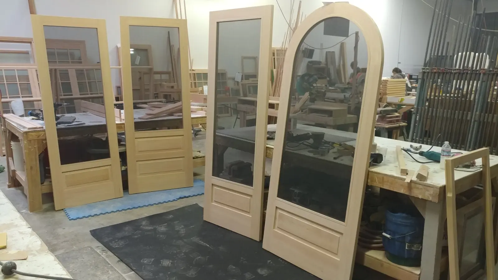 Custom wood screen doors displayed in the Wooddale shop