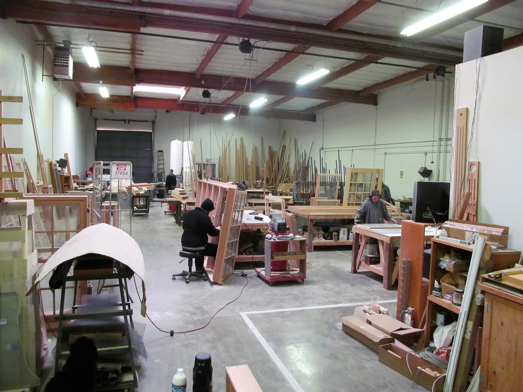 Craftspeople building custom wood windows inside the Wooddale shop