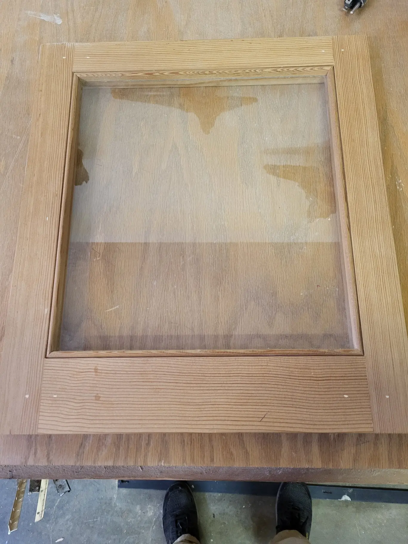 Exterior face of an unfinished wood glass storm sash on the Wooddale workbench