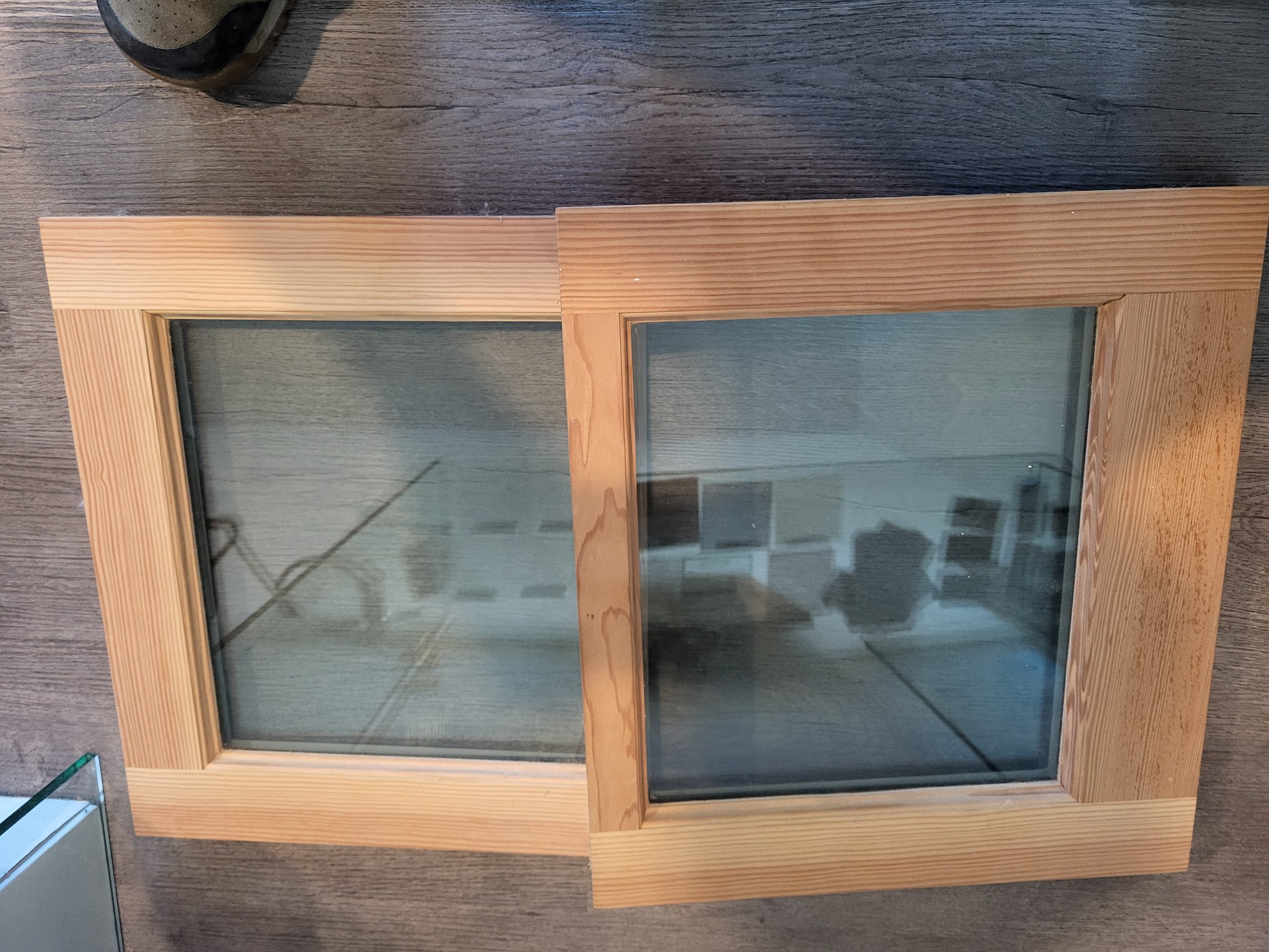 Two unfinished wood window sash with glass in the Wooddale shop