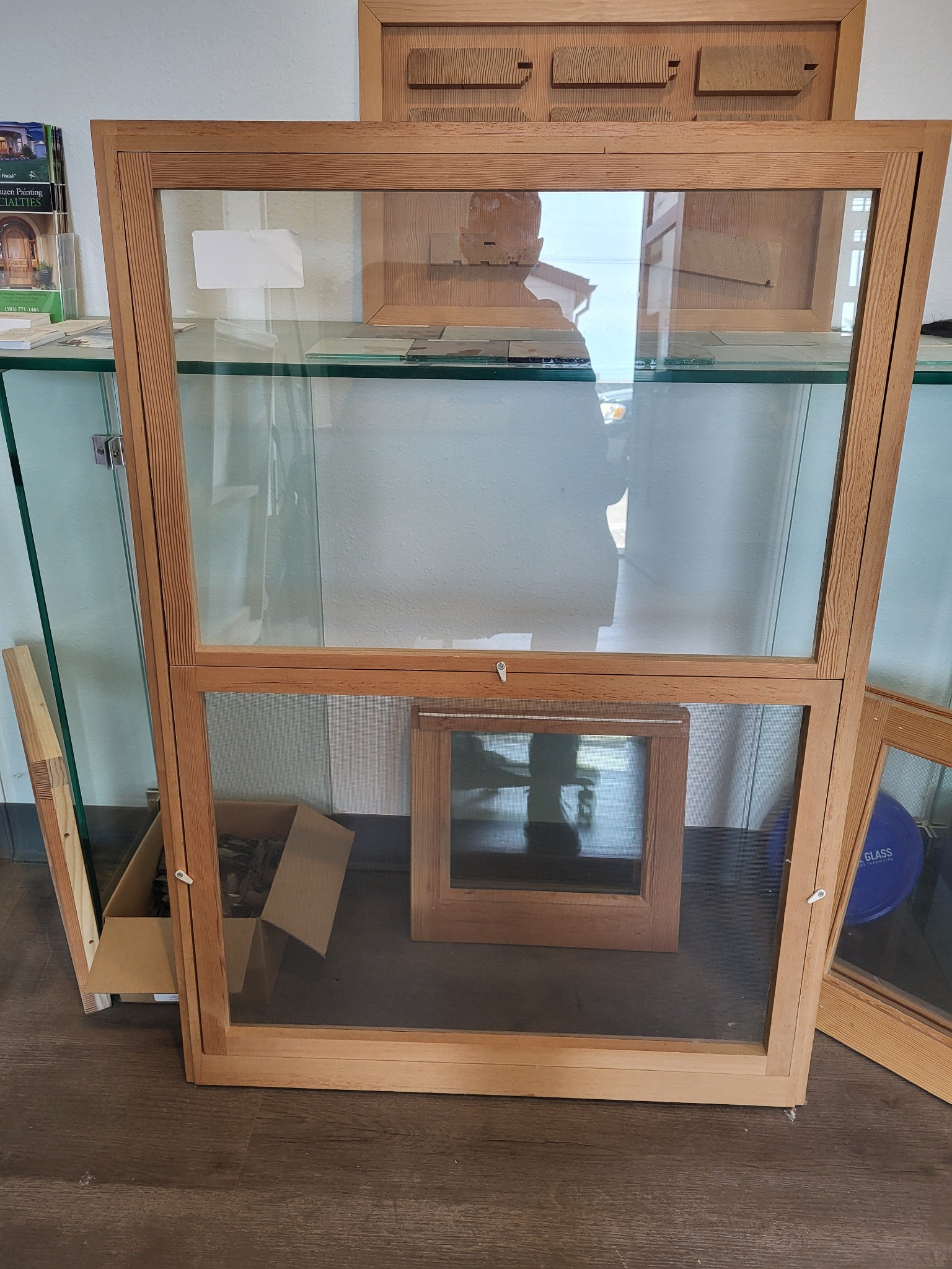 Wood storm-screen combination window with glass and screen panels in the Wooddale shop